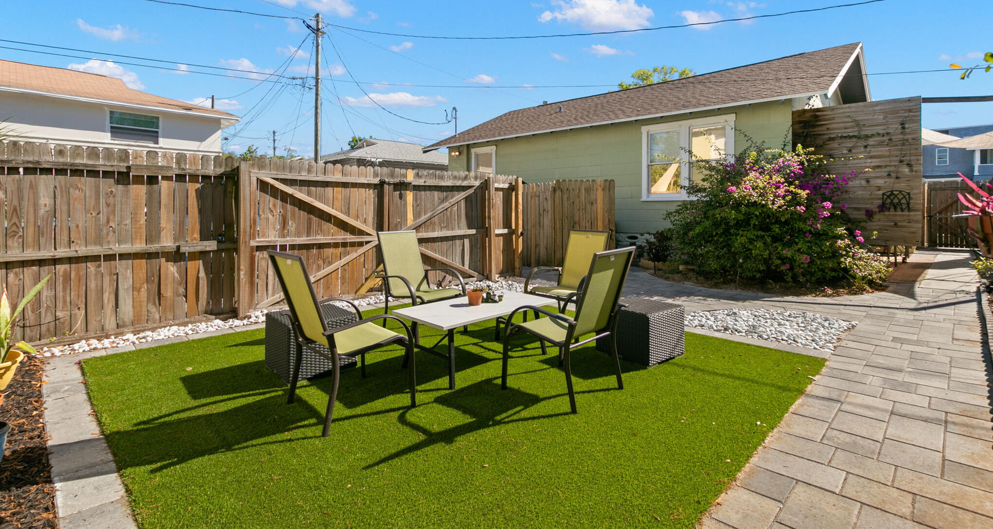 Ella House private fenced patio with outdoor dining, lounge seating and green space